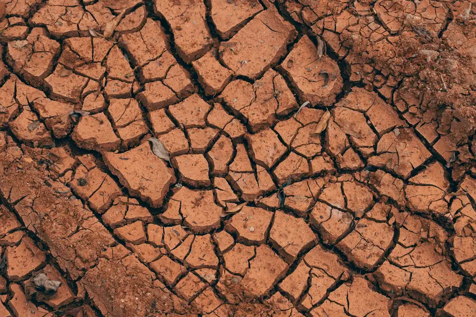 Cracked, dry red clay soil