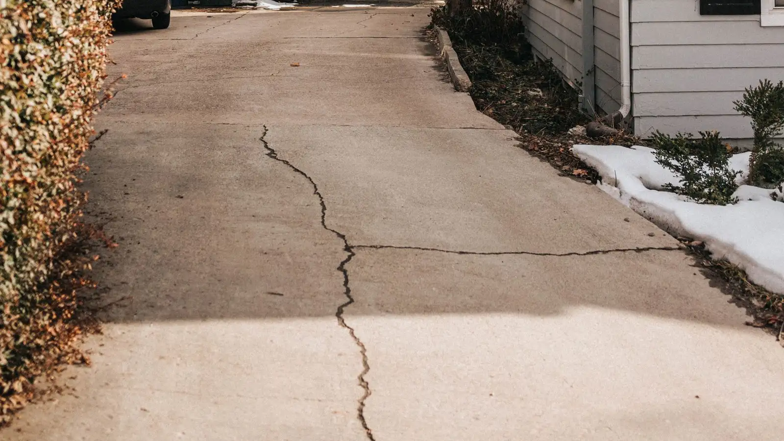 Cracked concrete driveway at a single-family home